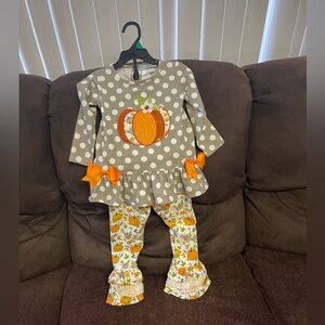 Size 3T/ Two piece Pumpkin outfit with flare bottom legs.